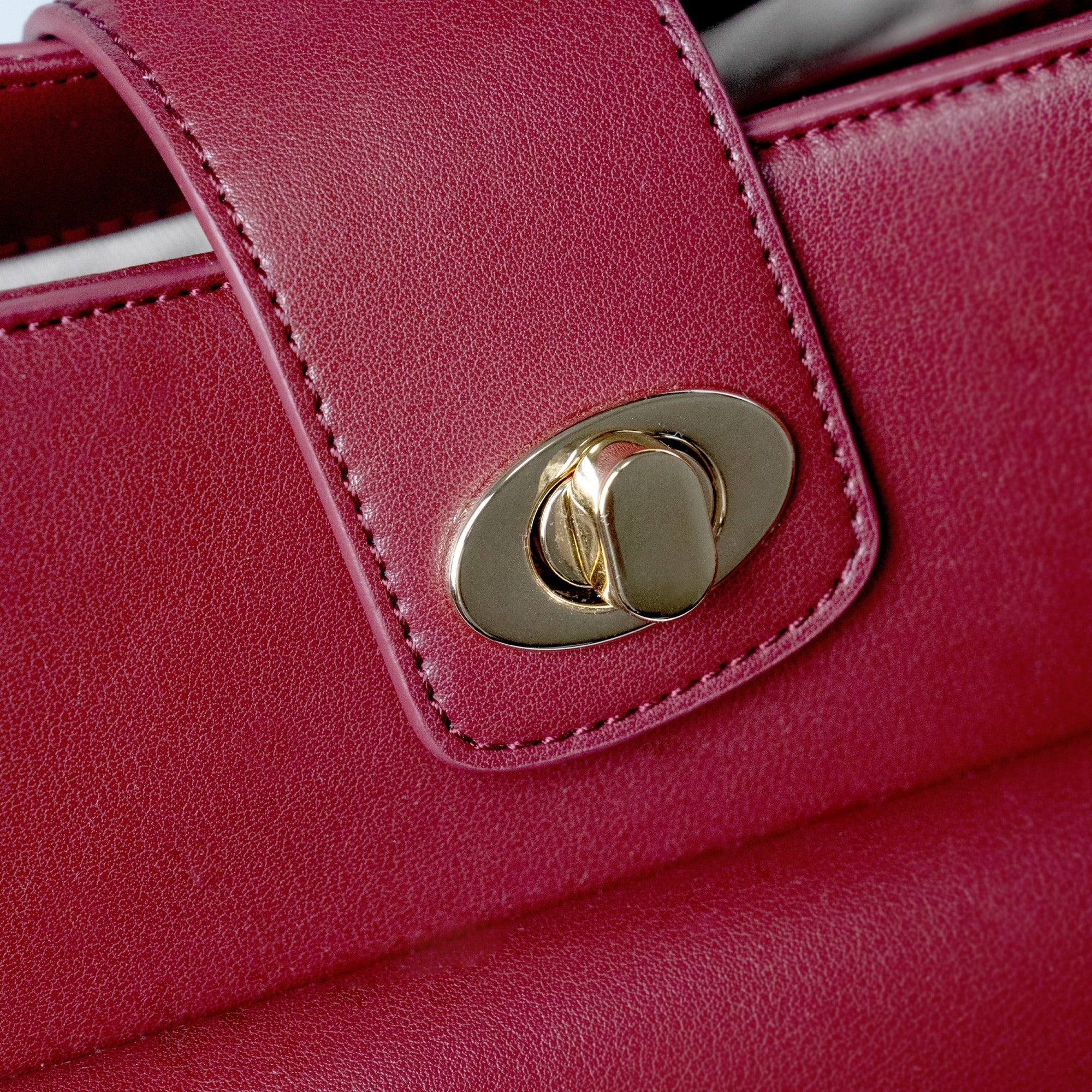 The Levain bag in Merlot burgundy on a park bench