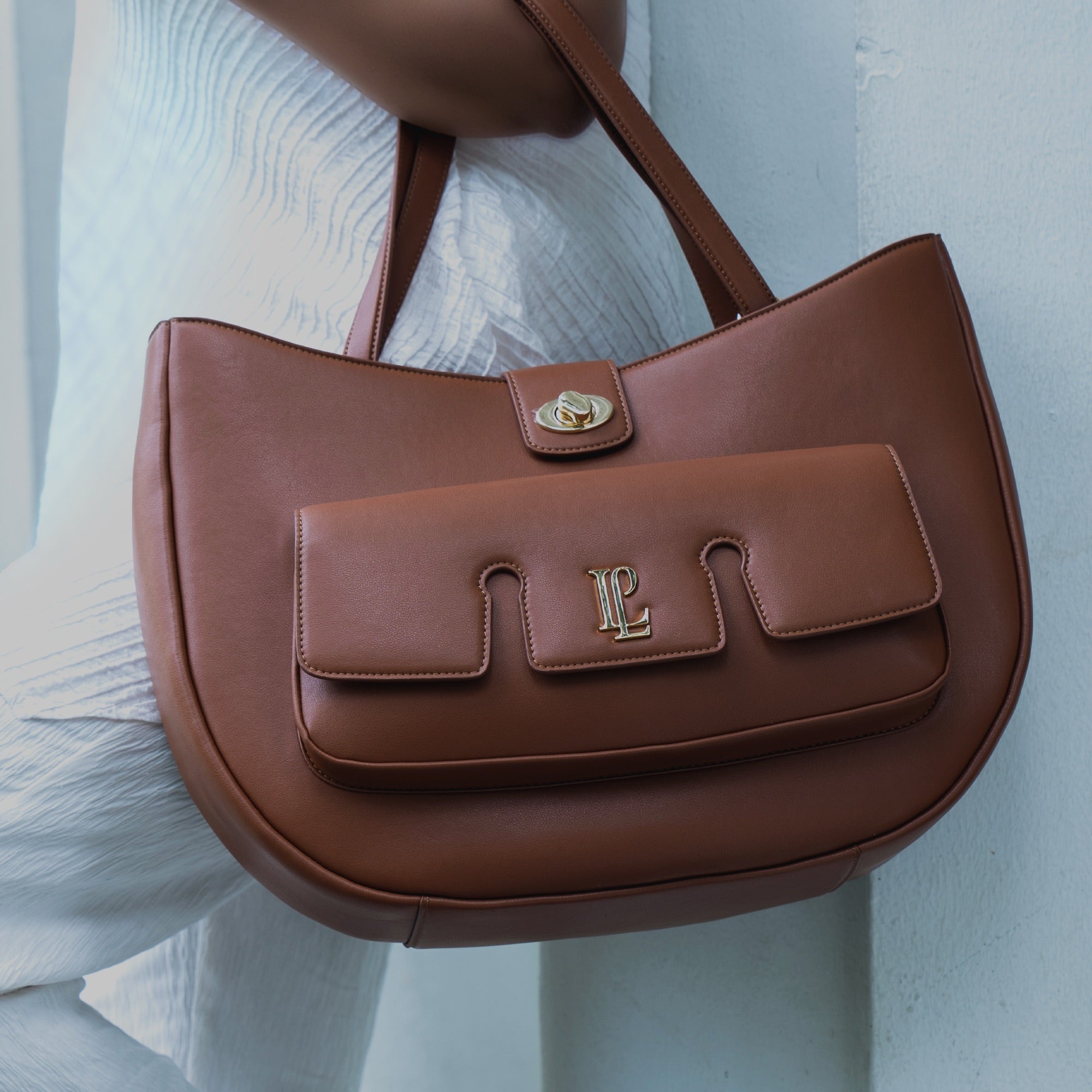 Four bags flatlay on grass